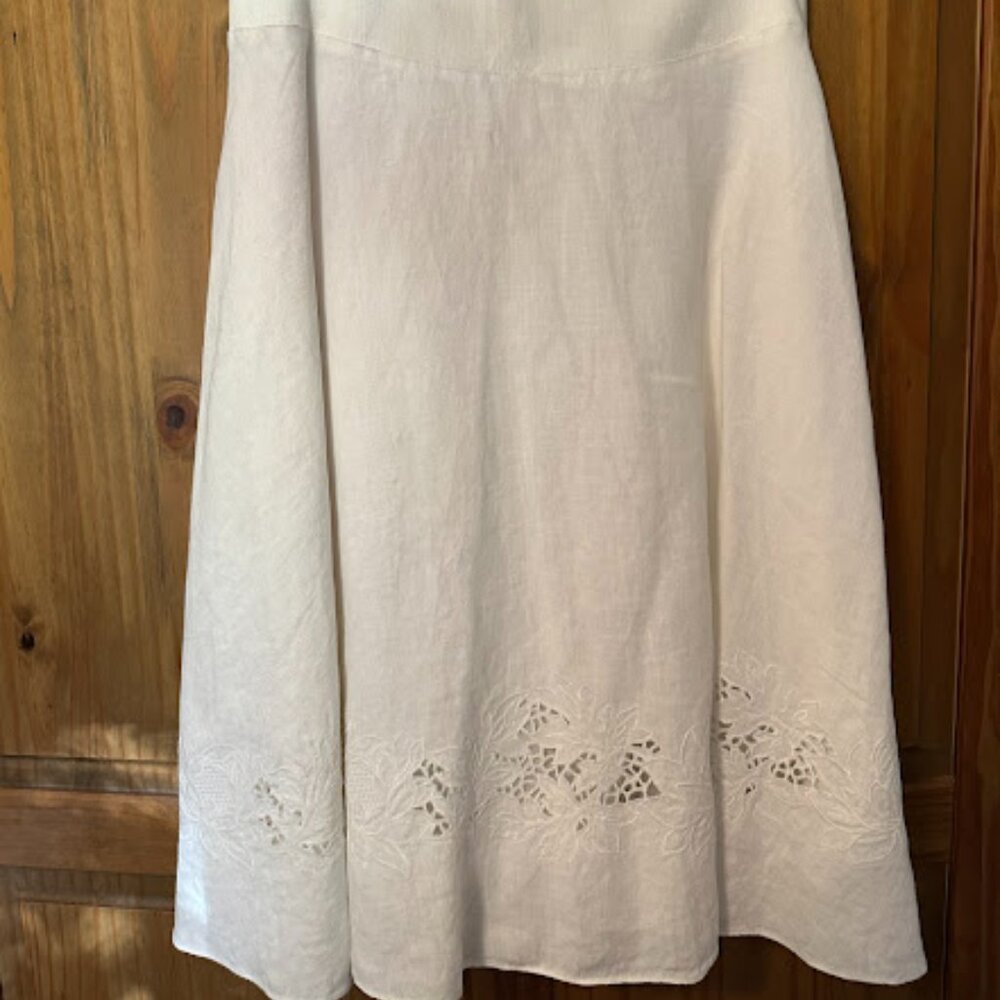 White skirt with eyelet detailing around bottom